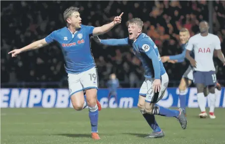  ??  ?? Steve Davies (left) celebrates wildly as Rochdale bag a last-gasp equaliser against Tottenham to clinch a replay trip to Wembley.