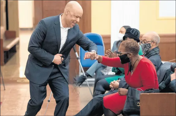  ?? KYLE TELECHAN / POST-TRIBUNE PHOTOS ?? Gary Mayor Jerome Prince bumps elbows with former Mayor Karen Freeman-Wilson during a ceremony for Freeman-Wilson’s mayoral portrait.