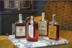  ??  ?? Prohibitio­n-era whiskeys in the Whisky Auctioneer American whiskey and bourbon auction include Old Overholt, Harry E. Wilken, I.W. Harper and Old Grand-dad.