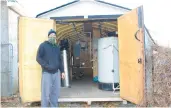  ?? MIKE RUBINKAM/AP ?? In this Jan. 4 photo, Tim Maye stands next to the shed outside his home with a water treatment system in Dimock, Susquehann­a County. Maye says his system, designed to remove gas drilling-related contaminan­ts from his well water, never seemed to work properly.