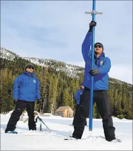  ?? Rich Pedroncell­i Associated Press By Hannah Fry ?? SEAN DE GUZMAN of the California Department of Water Resources measures the snowpack near Echo Summit in the first snow survey of the season in January.