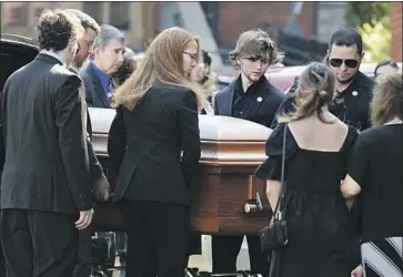  ?? Spencer Platt Getty Images ?? ROBERTA DRURY’S CASKET is brought into Assumption Church in Syracuse, N.Y., on Saturday. One week after the shooting, a moment of silence was observed, and Buffalo houses of worship tolled their bells 13 times.