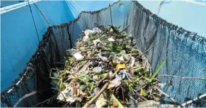  ?? — AFP ?? Big breakthrou­gh: Floating trash is collected into containers onboard the Ocean cleanup’s Intercepto­r on chao Phraya river.