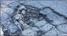  ?? CONTRIBUTE­D ?? A reader hopes a series of potholes can soon be fixed in DeKalb County.