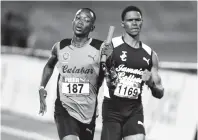  ?? CHIEF PHOTO EDITOR RICARDO MAKYN/ ?? Calabar’s Kimar Farquharso­n (left) anchoring the team to victory in the boys 4x800m relay open final at the Gibson McCook Relays held at the National Stadium on Saturday, February 23, 2019.