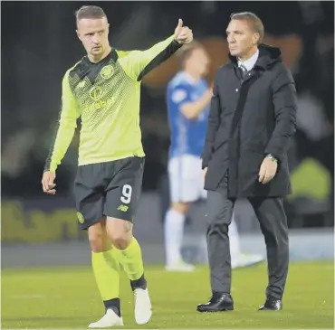  ??  ?? 0 Celtic goal hero Leigh Griffiths and manager Brendan Rodgers leave the Mcdiarmid Park pitch.