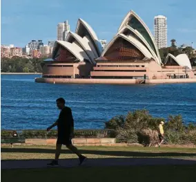  ??  ?? Changes galore: People strolling through a park in front of the Sydney Opera House. The country’s Jobmaker programme will focus on linking education funding toward skills needed by businesses.