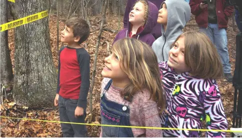  ??  ?? Students from the Mayapple School in Floyd, Virginia, who came to see civil disobedien­ce in action, shout questions up to the younger Terry. Police have stopped allowing family and friends to bring them food and water. There is some, but they’d have to...