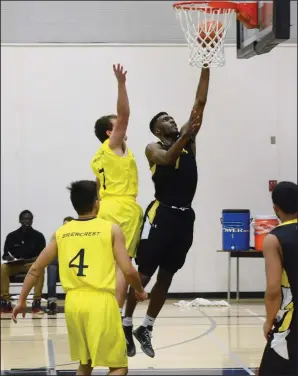  ?? NEWS PHOTO RYAN MCCRACKEN ?? Medicine Hat Rattlers guard Osato Obaseki drops in a layup during the third quarter of Saturday’s Alberta Colleges Athletics Conference men’s basketball game against the Briercrest Clippers at the Snake Pit. Obaseki recorded a game-high 18 rebounds to...