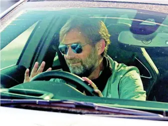  ?? AP ?? Liverpool manager Jurgen Klopp waves as he arrives at the club’s Melwood training ground after the English Premier League announced players can return to training in small groups as the coronaviru­s lockdown was eased on Wednesday May 20.