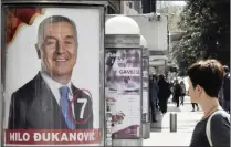  ?? PICTURE: RISTO BOZOVIC/AP ?? A woman walks past a billboard of Montenegro’s long-time leader, Milo Djukanovic, in Montenegro’s capital, Podgorica.