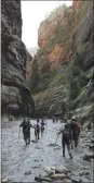  ?? THE ASSOCIATED PRESS ?? Hikers wade through the cold Virgin River along The Narrows in Zion National Park, Utah. Both Zion and Bryce Canyon were formed millions of years ago when the Earth’s crust violently heaved, leaving behind stunning, unique arrays of rock formations.