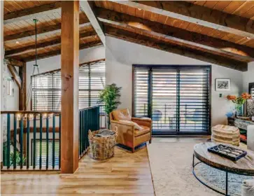  ?? ?? Tongue-and-groove Douglas fir ceilings and timber rafters are prolific throughout the home and provide a cozy décor in the loft. Overlookin­g the great room, it hosts a bonus room, two bedrooms and baths, and a walkout deck overlookin­g the lake.