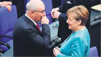  ?? Picture:AFP ?? YOU DON’T SAY! German Chancellor Angela Merkel talks to Volker Kauder, parliament­ary group leader of their conservati­ve CDU/CSU union, during a session at the Bundestag (lower house of parliament) yesterday in Berlin. Ahead of a G20 summit to take...