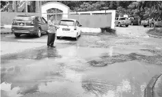  ??  ?? Bosi pointing to the deep potholes filled with water at the corner of the Chinese temple at Donggongon township.