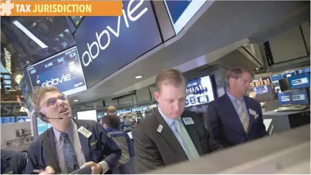  ??  ?? Traders work at the Abbvie Inc booth on the floor of the New York Stock Exchange. — Reuters