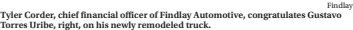  ?? Findlay ?? Tyler Corder, chief financial officer of Findlay Automotive, congratula­tes Gustavo Torres Uribe, right, on his newly remodeled truck.