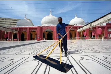  ?? ?? A Pakistani man cleans a mosque in preparatio­n for the upcoming Muslim fasting month of Ramadan, in Karachi, Pakistan, Saturday, March 9, 2024. (AP Photo/Fareed Khan)