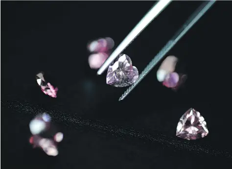  ?? ROBERT GILHOOLY/BLOOMBERG FILES ?? Rare pink diamonds are displayed at the Rio Tinto Diamonds office in Tokyo. Rio “has a deep experience and expertise in the diamond exploratio­n and mining business and looks forward to working on this growth opportunit­y for diamonds,” it said Tuesday.