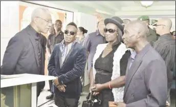  ?? Presidency photo) (Ministry of the ?? President David Granger (left) expressing his condolence­s to the children of the late Malcolm Corrica aka Lord Canary