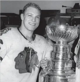  ?? ASSOCIATED PRESS FILE PHOTO ?? In this April 16, 1961, photo, Chicago Blackhawks left-winger Bobby Hull reacts in the dressing room after defeating the Red Wings to win the Stanley Cup in Detroit.