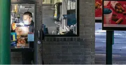  ?? Chris Machian / Associated Press ?? A law enforcemen­t officer dusts for fingerprin­ts, where two people were killed and two others hurt in a shooting at a Sonic restaurant in Nebraska.