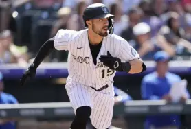  ?? David Zalubowski, The Associated Press ?? Rockies outfielder Randal Grichuk hits a single to drive in two runs in the seventh inning Sunday.