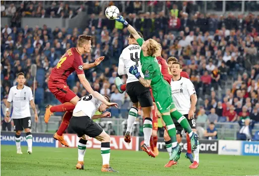  ?? AFP ?? Liverpool’s goalkeeper Loris Karius (right) clears the ball during the Champions League semifinal second leg against AS Roma in Rome. —