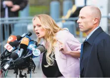  ?? Eduardo Munoz Alvarez / AFP / Getty Images ?? Adult-film actress Stephanie Clifford, also known as Stormy Daniels, speaks to reporters with her lawyer Michael Avenatti.