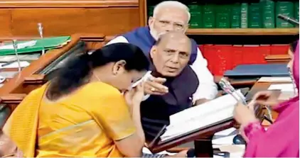  ??  ?? Finance Minister Nirmala Sitharaman seen trying to wipe the excess sweat off her forehead. She was offered candies and advised to sit down. Reportedly, her blood pressure had fallen that caused the perspirati­on