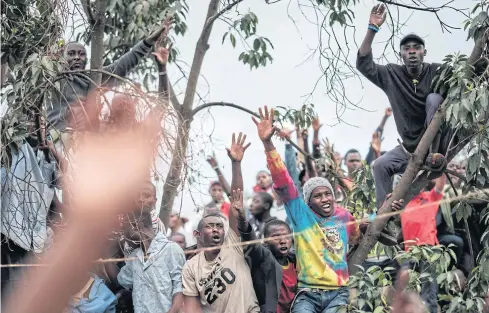  ?? AFP ?? Supporters react as Kenya’s opposition leader Raila Odinga of the National Super Alliance (NASA) coalition, speaks during a political rally this month.