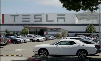 ?? AP PHOTO/BEN MARGOT ?? Vehicles are seen parked at the Tesla car plant Monday, in Fremont, Calif.