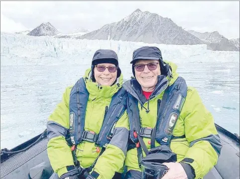  ?? Submitted photo ?? Denise and Jim Klinger of Bella Vista are pictured in a Zodiac with a glacier in the background during their recent trip to Antarctica.