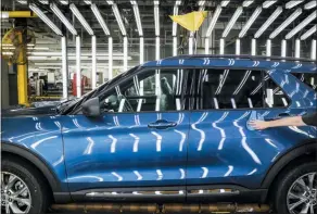  ?? AMR ALFIKY — THE ASSOCIATED PRESS FILE ?? In this file photo a Ford employee works on a Ford Explorer line at Ford’s Chicago Assembly Plant in Chicago’s Hegewisch neighborho­od. Ford Motor Co. reports earning onWednesda­y.