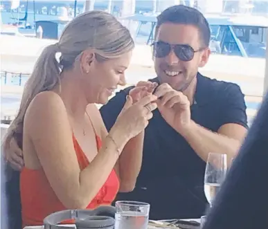  ??  ?? Australia's favourite bacheloret­te Sophie Monk tries on a fake moustache with her new beau at Omeros Bros Seafood Restaurant on the Gold Coast.