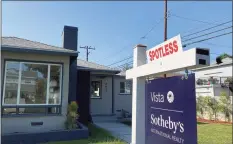  ?? Chris Delmas / TNS ?? A real estate sign is seen in front of a house for sale in West Los Angeles on Nov. 19.