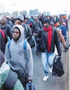  ?? / AP ?? Migrantes esperando a registrars­e en un centro de procesamie­nto en el campo improvisad­o conocido como “La jungla”, cerca de Calais, al norte de Francia.