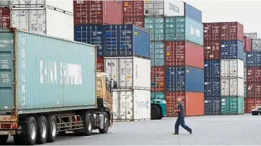  ??  ?? Steady growth: A labourer works at a port in Tokyo. Japan’s economy expanded at an annualised 2.5% in the second quarter.