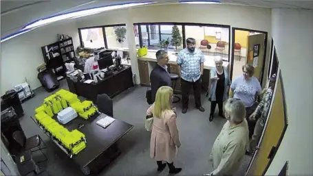  ?? Coffee County, Ga. ?? COFFEE COUNTY, GA., elections office security video captured unusual activity in January 2021, including this image of then-county Republican Party Chair Cathy Latham, center, apparently introducin­g members of a computer forensic team to local election officials.