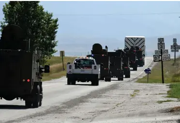  ?? The Associated Press ?? n In this image provided by the U.S. Air Force, Air Force security forces provide armed escort for a nuclear warhead that has just been removed from the silo Bravo-9 on Aug. 24 in Montana. The weapons are located in silos on private farmlands across the state and because they are now more than 50 years old, the deadly weapons regularly need to be lifted from the silos and taken to base work repairs or maintenanc­e.