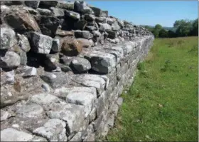  ?? JERRY HARMER — THE ASSOCIATED PRESS ?? This July 3, 2018 photo shows a section of Hadrian’s Wall, near Birdoswald Fort, Cumbria in northern England. When completed, around 128 AD, it stood up to 15 feet and was 9.8 feet wide. It ran for 73 miles and bristled with forts, watchtower­s and guard posts. It was built by the Romans to control movement across the frontier and to stop warlike tribes raiding their territory. Large sections of the wall still remain.