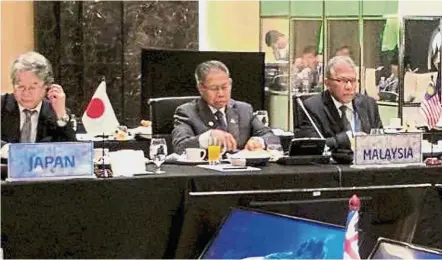  ??  ?? At the summit: Mustapa, Miti’s secretary-general and TPP’s chief negotiator Datuk Seri J. Jayasiri (right) at the TPPA ministeria­l meeting in Hanoi.