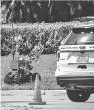  ?? TAIMY ALVAREZ / SOUTH FLORIDA SUN-SENTINEL VIA AP ?? A bomb defusing robot is sent into the building housing U.S. Rep. Debbie Wasserman Schultz’s office in Florida.