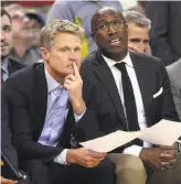  ??  ?? Head coach Steve Kerr and assistant Mike Brown watch the fourth quarter unfold. The Kings led by a point after three quarters, then trailed by four with two minutes left before winning by four.