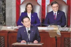  ?? ASSOCIATED PRESS ?? Japan’s Prime Minister Fumio Kishida addresses a joint meeting of Congress in the House chamber Thursday at the Capitol in Washington, as Vice President Kamala Harris and Speaker of the House Mike Johnson, R-La., look on.
