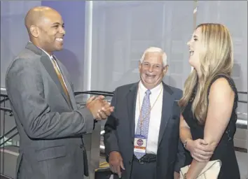  ??  ?? Siena College men’s basketball head coach Jamion Christian, left, and his wife, Allie, laugh with Prime Companies owner Ken Raymond.