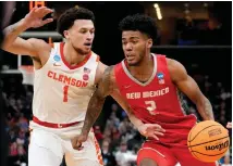  ?? GEORGE WALKER IV / ASSOCIATED PRESS ?? UNM’s Donovan Dent dribbles past Clemson’s Chase Hunter during Friday’s NCAA Tournament game in Memphis, Tenn. Retaining Dent, a sophomore point guard, will likely be among the Lobos’ priorities in the offseason.