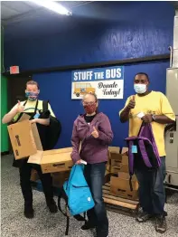  ?? Photo courtesy of Jennifer Lewis ?? ■ From left: Caleb Parker, Kay Grace and Michael Hall at last year’s “Stuff the Bus” program.