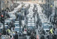  ?? PICTURES: PA WIRE. ?? UBER ROW: Taxis fill Fleet Street during a protest in London by the United Cabbies Group (UCG).