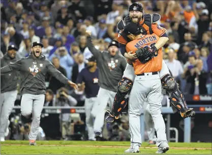  ?? MATT SLOCUM — ASSOCIATED PRESS ?? Astros catcher Brian McCann leaps in the arms of pitcher Charlie Morton after beating the Dodgers in Game 7 of the World Series.